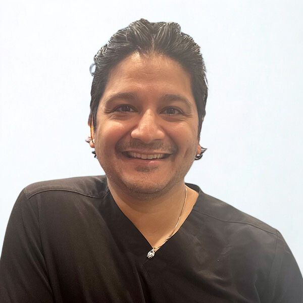 Young Woman Smiling By Green Wall